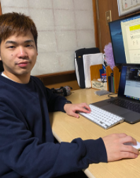 Akamine studying on a desk